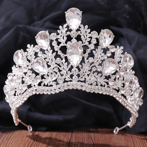 Close-up of silver baroque tiara featuring pear-cut crystals and intricate leaf detailing