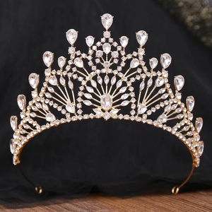 Detailed view of vintage gold bridal crown with sparkling rhinestone crystals on black lace