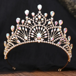 Detail showing gold baroque crown with marquise crystals on a black background