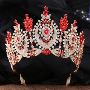 Macro shot of Baroque gold tiara featuring intricate red teardrop gems and white rhinestones