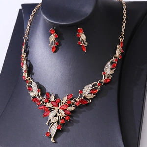 Detail of bridal jewelry set with red and white rhinestones on leaf pattern necklace