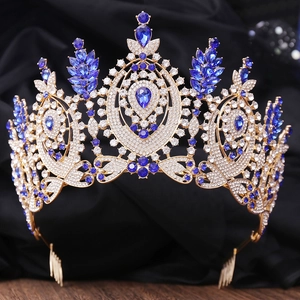 Detailed macro view of baroque gold tiara with blue rhinestones and secure metal combs
