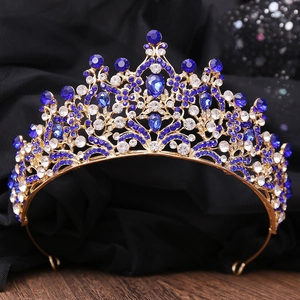 Detailed view of luxury bridal tiara with golden leaf textures and blue rhinestones