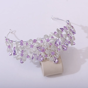 Detailed macro view of silver leaf crown with purple crystals and sparkling rhinestones