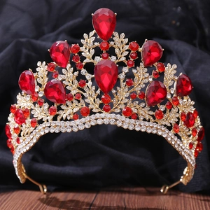 Detailed macro view of baroque gold crown with red teardrop crystals and pave-set rhinestones