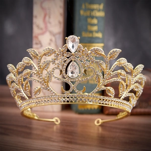 Detailed macro of golden bridal crown featuring leaf motifs and teardrop crystals