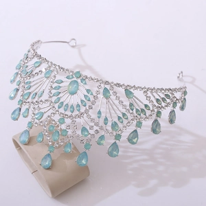 Detail of vintage Baroque crown featuring blue teardrop rhinestones on silver base