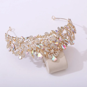 Detailed close-up of golden leaf crown with shimmering rhinestones and AB crystals