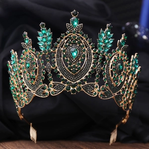 Detail of Baroque gold bridal crown featuring dark green emerald rhinestones and comb