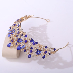 Macro detail of golden leaf tiara with deep blue crystals and shimmering rhinestones