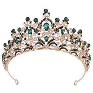 Exquisite gold bridal crown set with emerald and white rhinestones on white background