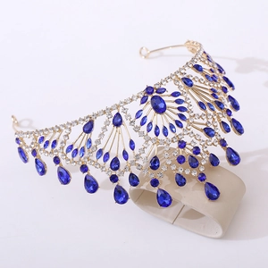 Detailed side view of a gold baroque bridal crown with blue teardrop gems and rhinestones