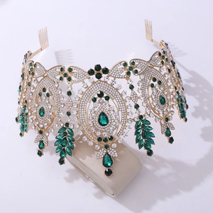 Detailed view of Baroque crown with green emerald-style gems and gold alloy base