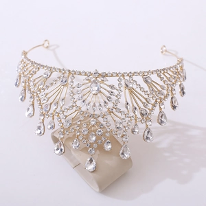 Detail of golden Baroque bridal crown featuring white rhinestones and teardrop pendants