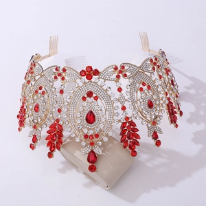 Detailed close-up of Baroque gold crown with deep red teardrop gems and crystals