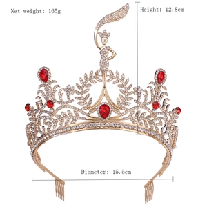 Detailed view of gold pageant crown with red teardrop stones and dimensions shown