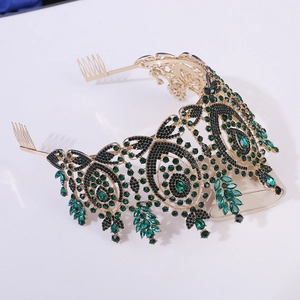 Detailed side view of baroque crown with emerald and black rhinestones on gold alloy base