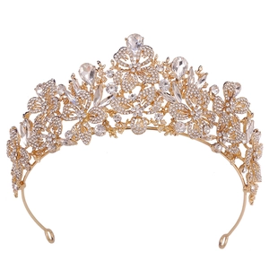 Close-up of golden leaf crown with sparkling rhinestones and butterfly patterns