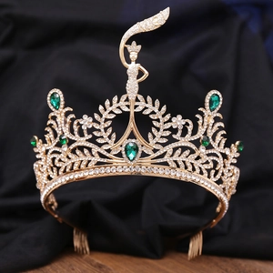 Macro shot of gold bridal crown featuring emerald green gems and central goddess motif