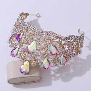 Detail of golden Baroque bridal crown with intricate leaf patterns and AB crystal teardrops