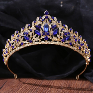 Detailed craftsmanship of golden crown featuring dark blue gems and white crystals