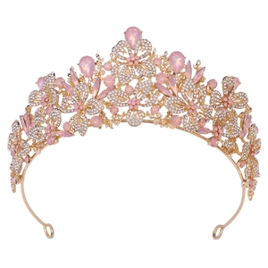Detailed view of pink crystal leaves and rhinestones on the gold bridal tiara crown