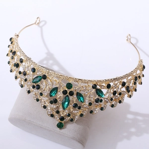 Detail of golden tiara with emerald green marquise crystals and white rhinestones
