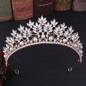 Baroque bridal crown with gold crystal leaves and pearls on vintage background