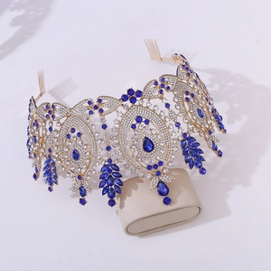 Detail of baroque gold crown featuring navy blue pear-shaped crystals and fine rhinestones