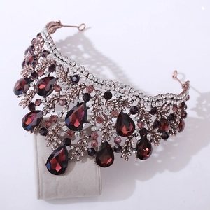 Detail of baroque bridal crown with dark red teardrop crystals and vintage bronze metal