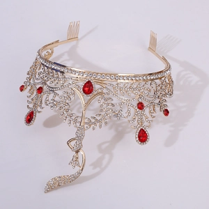 Detail of luxury gold crown with red teardrop gems and sparkling white rhinestones