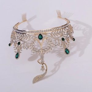 Detailed shot of golden baroque tiara featuring emerald crystals and teardrop rhinestones