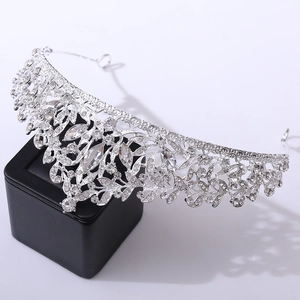 Close-up of elegant silver bridal crown with intricate rhinestone floral leaf patterns