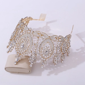 Detailed close-up of Baroque gold crown with sparkling rhinestones on display pillow