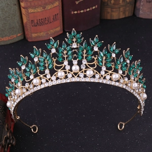 Detailed shot of Baroque golden tiara with green marquise stones and white pearls