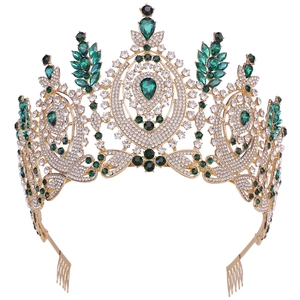 Macro shot of gold baroque tiara with emerald stones and white crystal embellishments