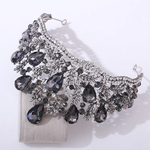 Macro shot of silver baroque crown with teardrop grey crystals and intricate leaf detailing