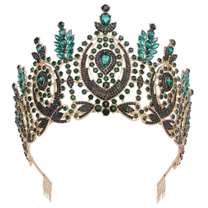 Detail of vintage gold crown with emerald green crystals and hair combs for styling
