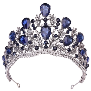 Detailed close-up of Baroque silver bridal crown with large blue crystals and white rhinestones