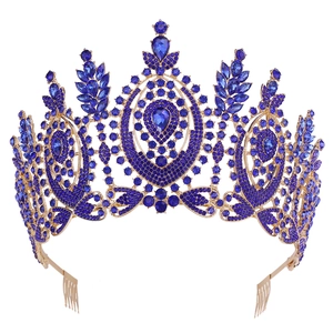 Close-up of golden Baroque tiara with teardrop blue crystals and built-in hair combs