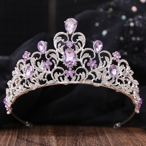 Close-up of silver bridal crown with purple crystals and sparkling rhinestone details