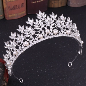 Baroque bridal crown with silver crystal leaves and white pearls on vintage background