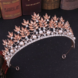 Close-up of rose gold bridal crown with champagne crystals, pearls and rhinestones