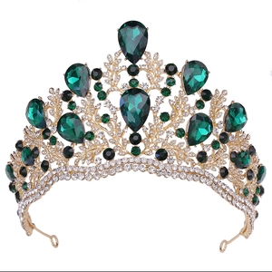 Golden Baroque bridal crown with emerald green crystals and intricate leaf carvings