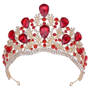 Close-up of baroque bridal crown featuring ruby red crystals and gold-plated details