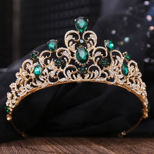 Detail of bridal crown featuring emerald green gems and white rhinestones on gold base