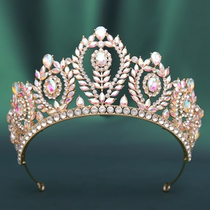 Close-up of golden Baroque bridal crown with iridescent rhinestones on green velvet