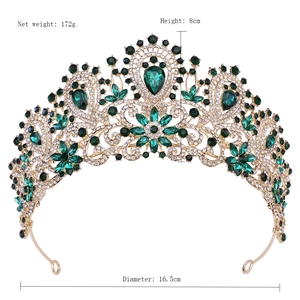 Macro detail of luxury silver bridal crown with deep green rhinestones and crystals