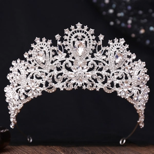 Macro view of bridal silver crown featuring Baroque floral patterns and pear-shaped rhinestones