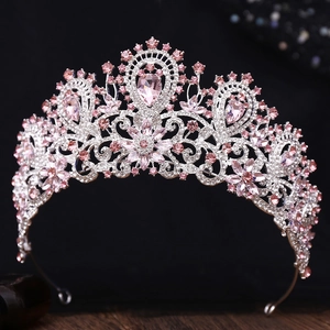 Detail of luxury bridal crown with pink and white rhinestones on a dark background